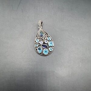 Silver pendant with expensive precious stones.